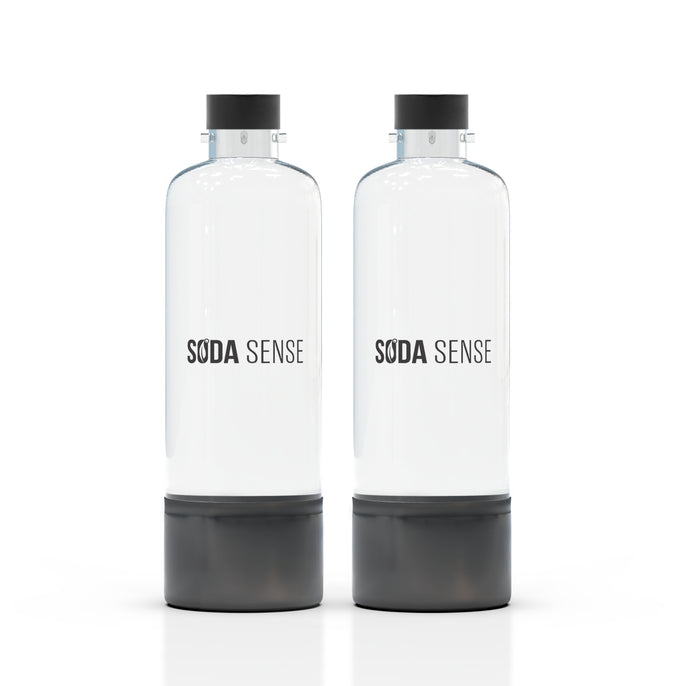 Two clear Soda Sense reusable bottles with black caps and bases, standing side by side on a white background.